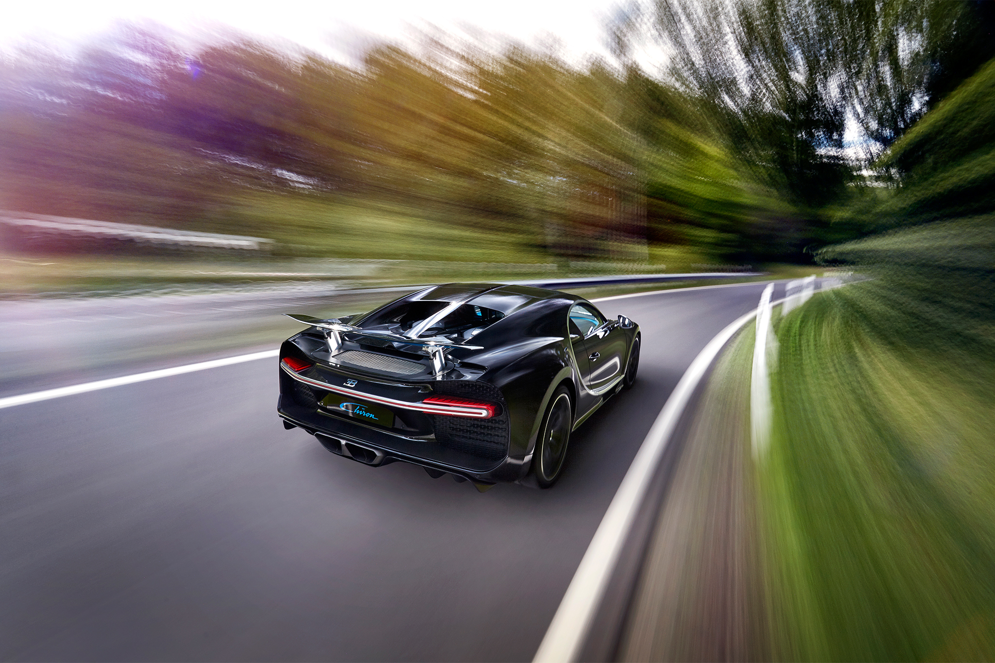 2017 Bugatti Chiron rear three quarter in motion 01
